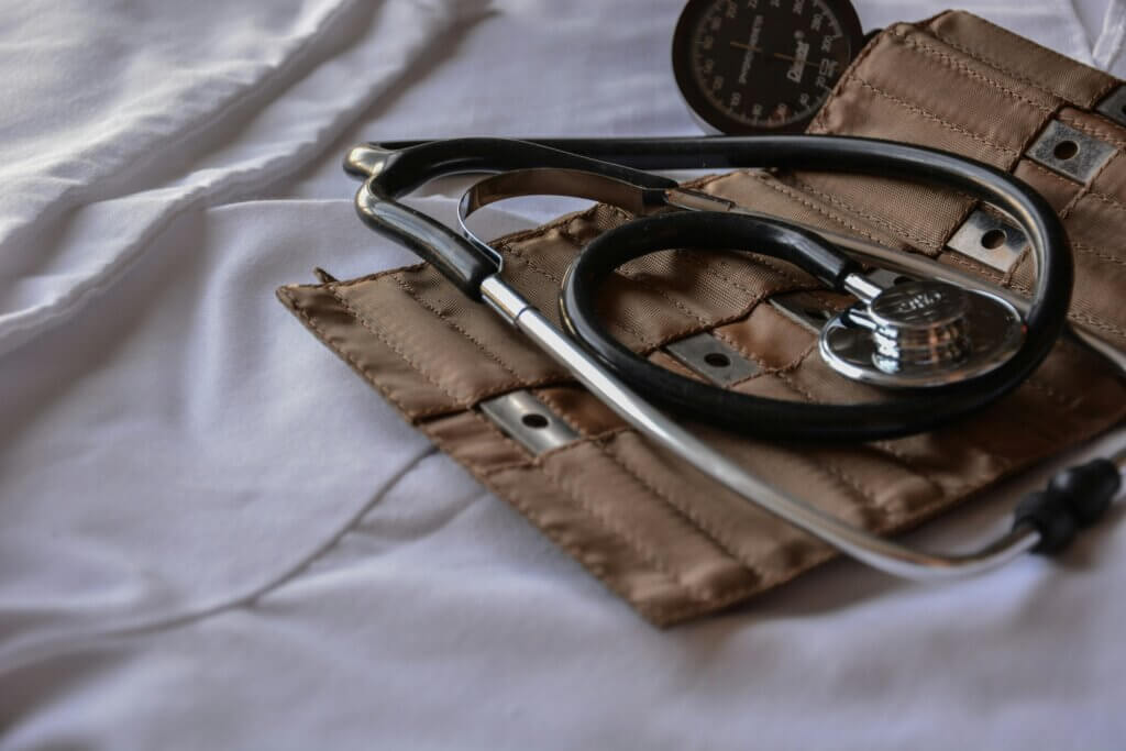 Doctor tools (i.e. stethoscope) against a white background