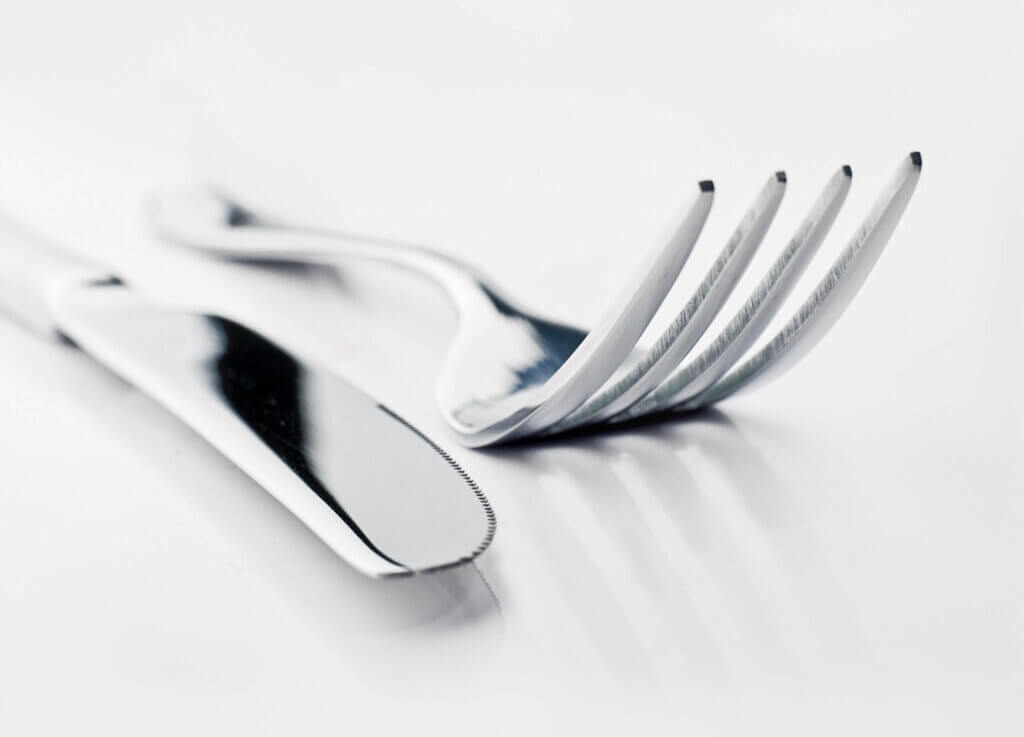 Silver fork and knife against white background