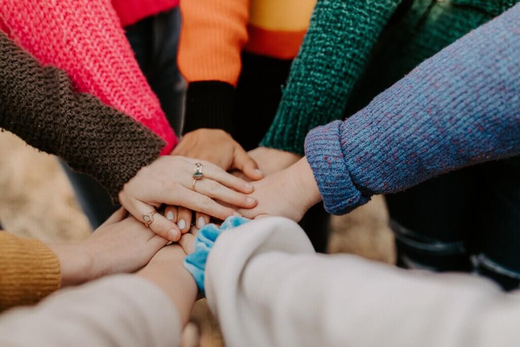 hands piled together showing community.
