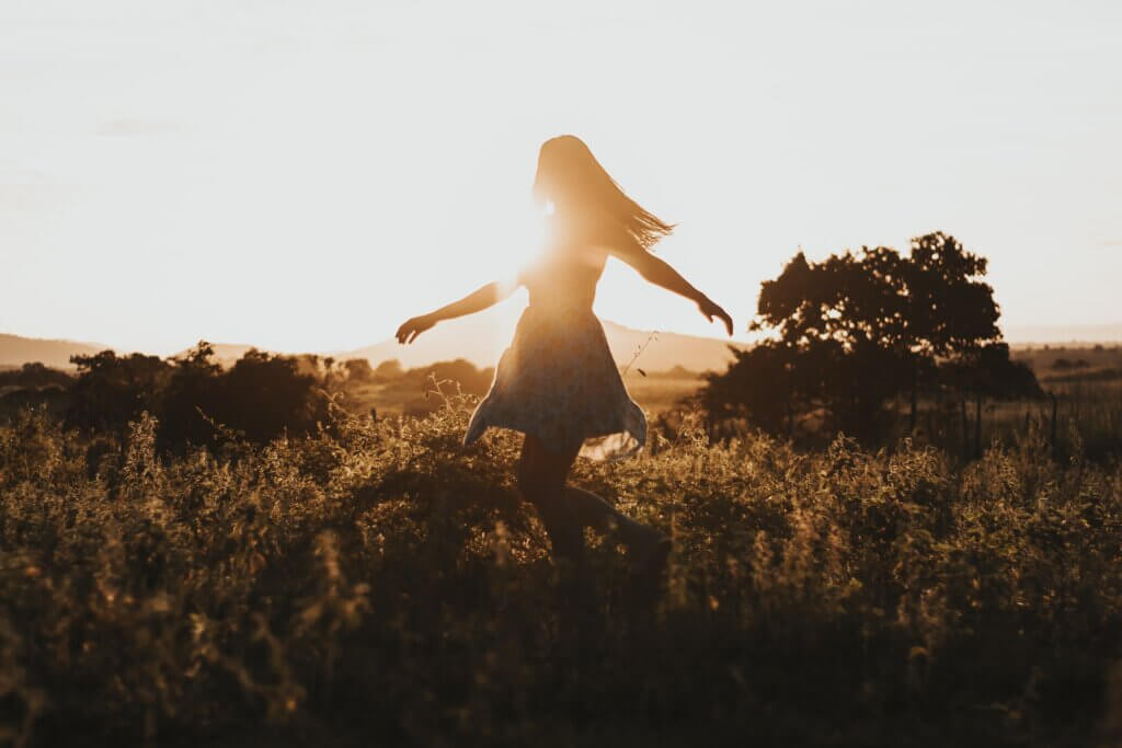 woman walking through a field