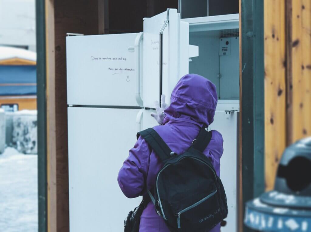 person opening community fridge