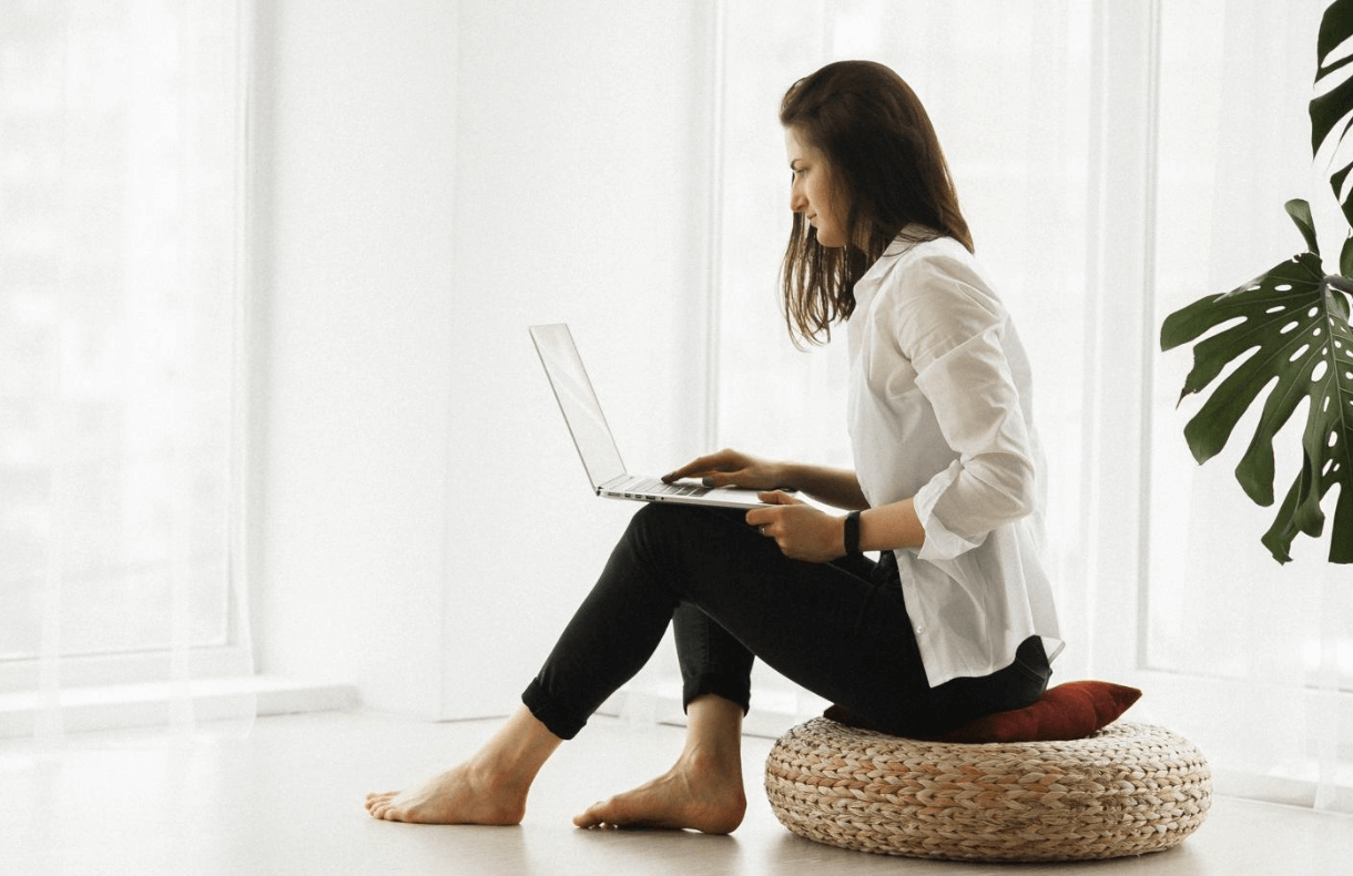 Someone sitting down and working on laptop.