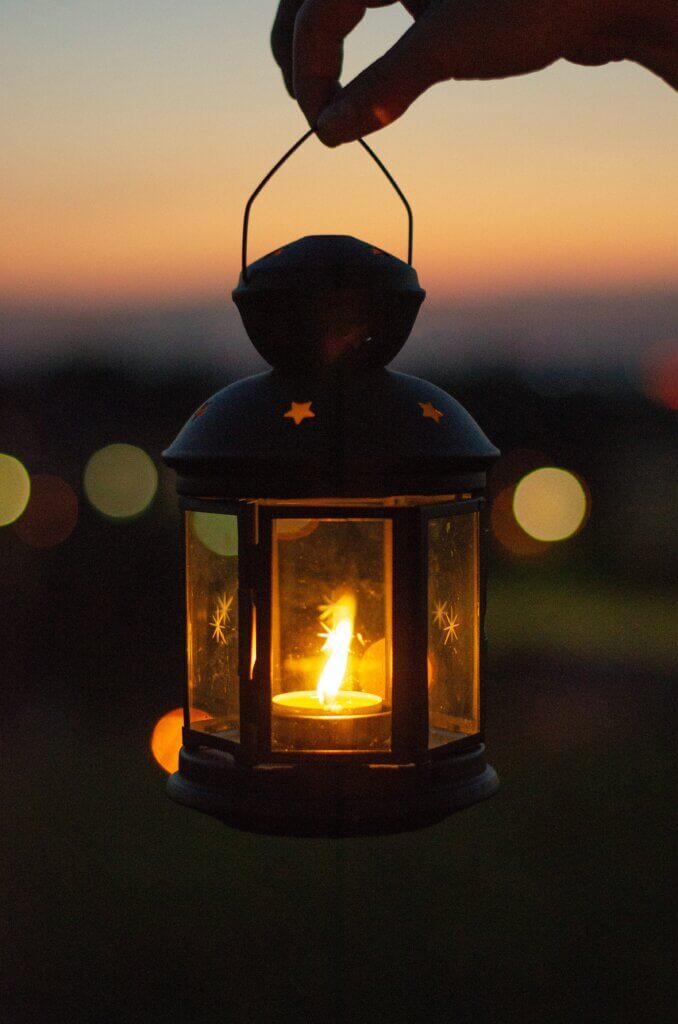A lit lantern at sunset.