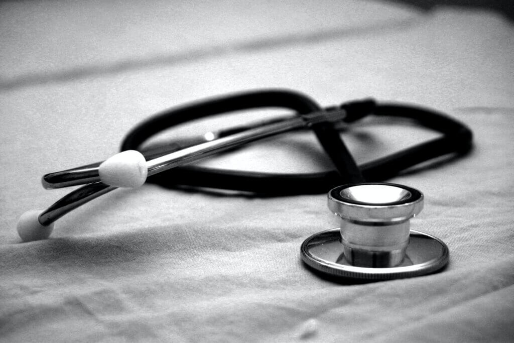 Black and white image of stethoscope on a sheet