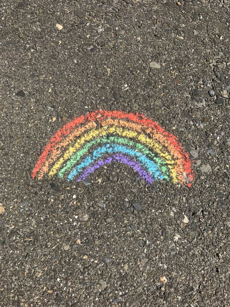 Rainbow drawn on asphalt with chalk