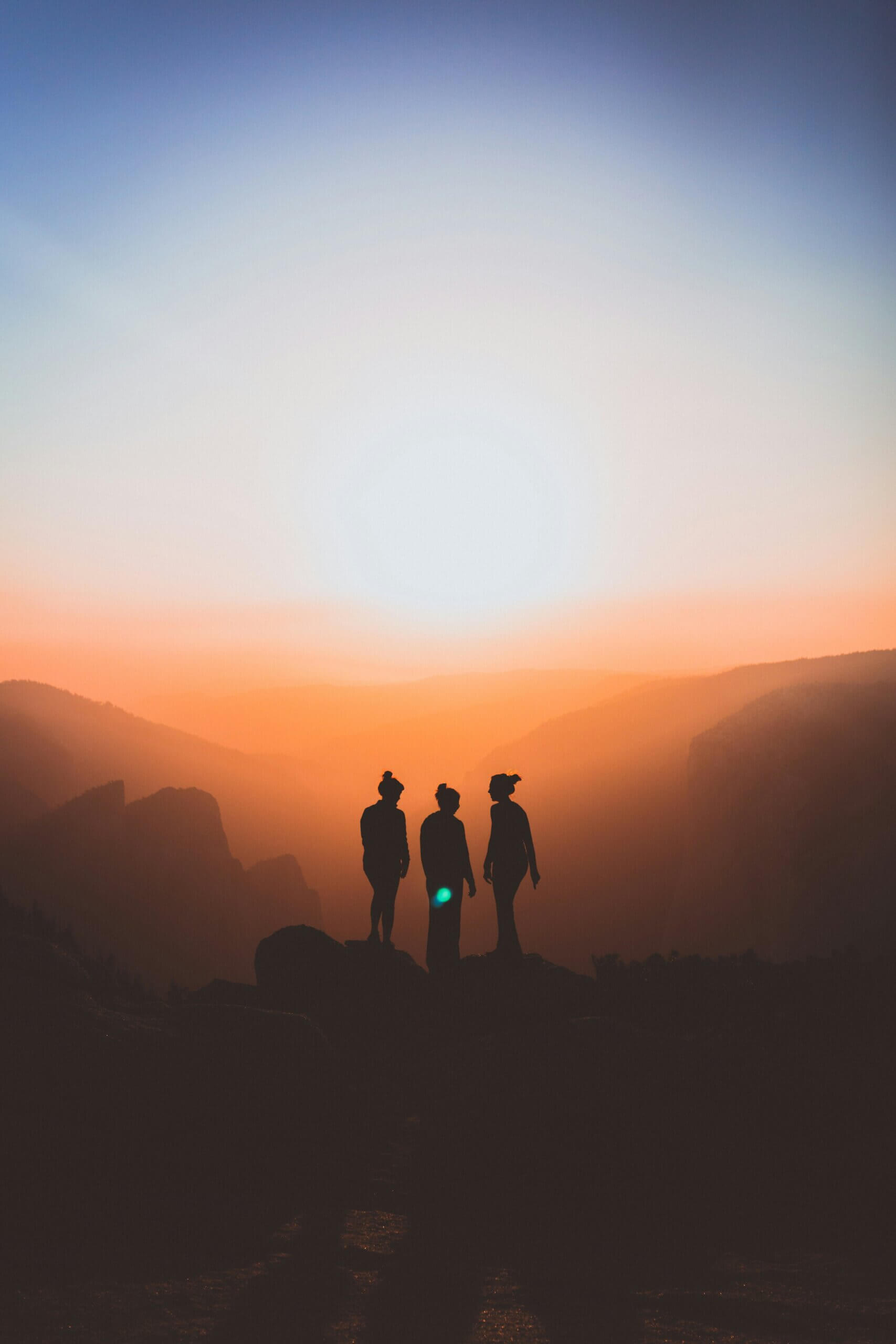 Silhouette of three women against the sunset
