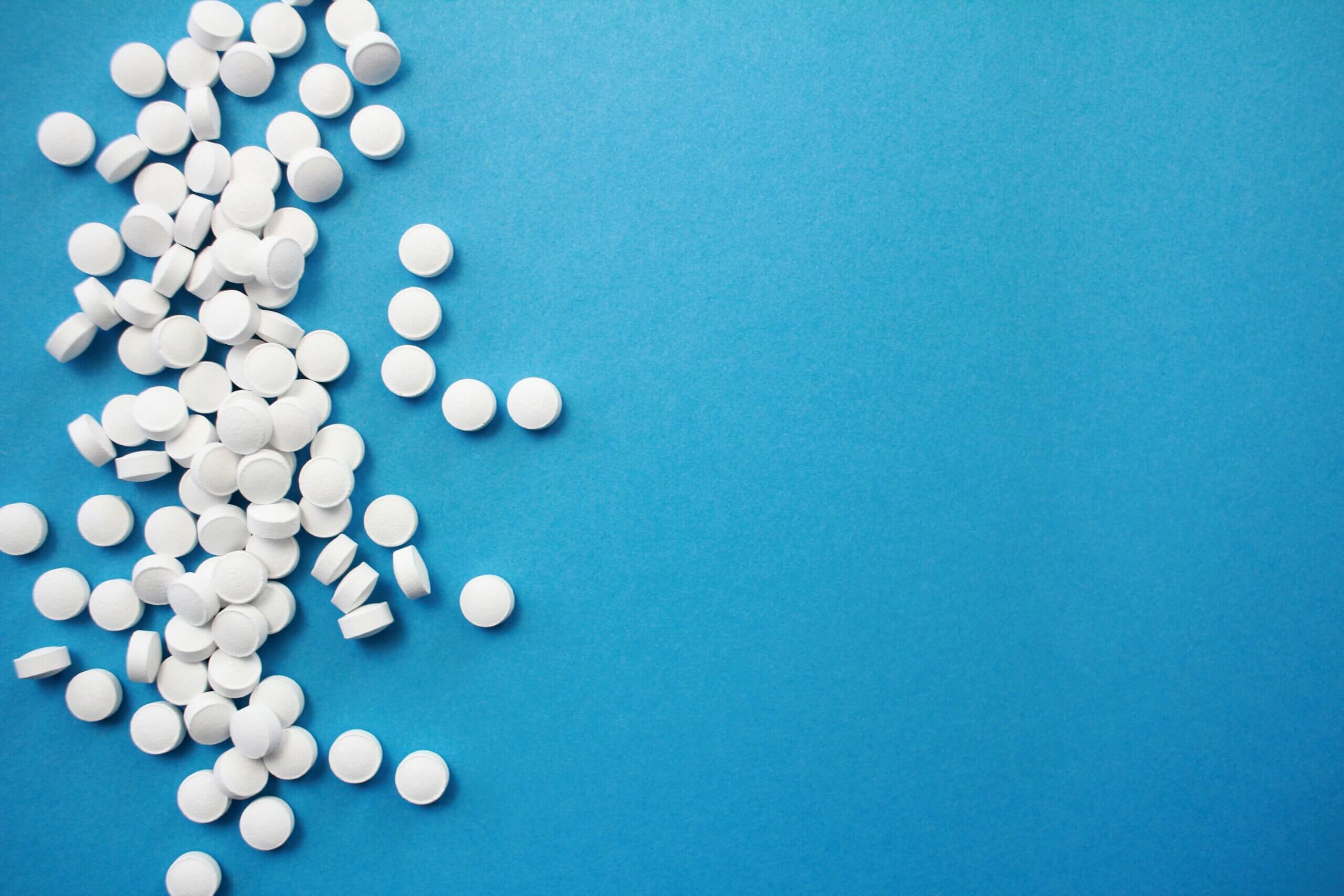 White pills against a blue background