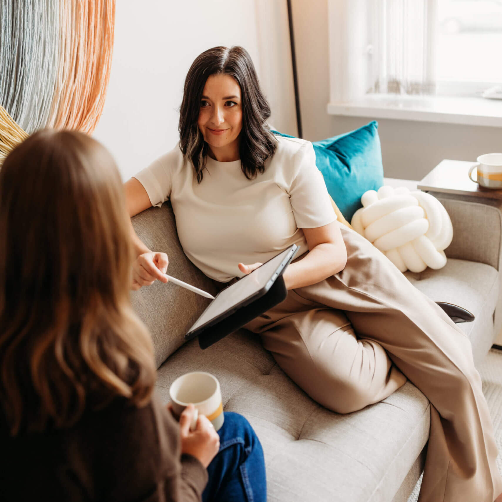 Jillian showing a client something on an iPad.