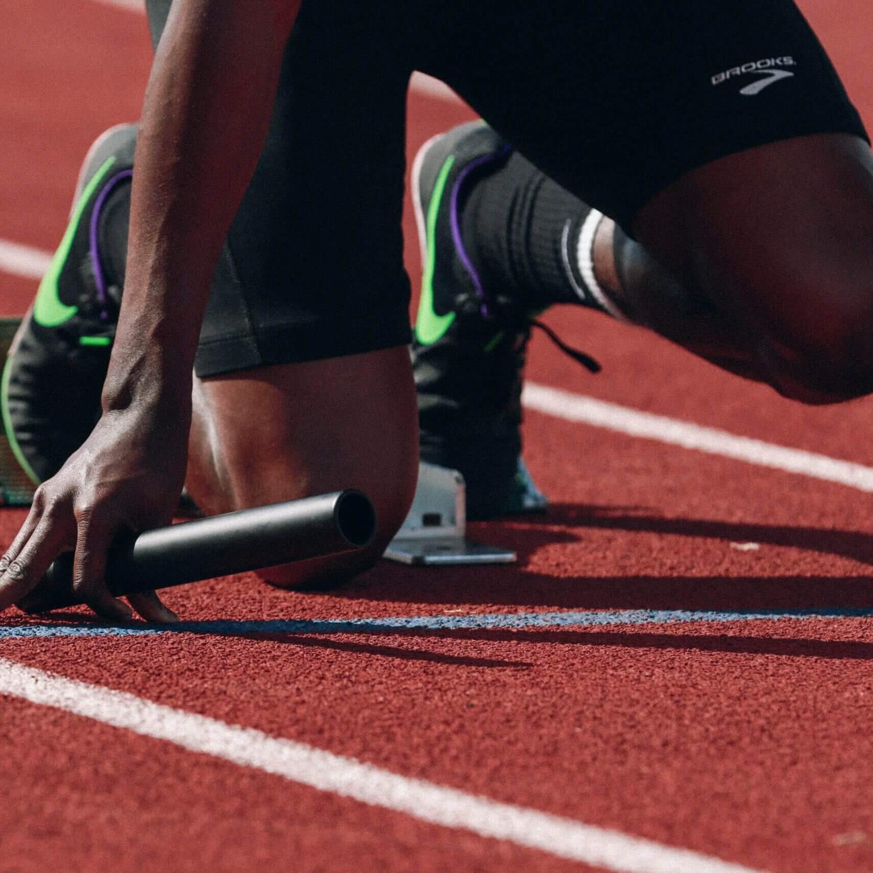 athlete on track with a baton